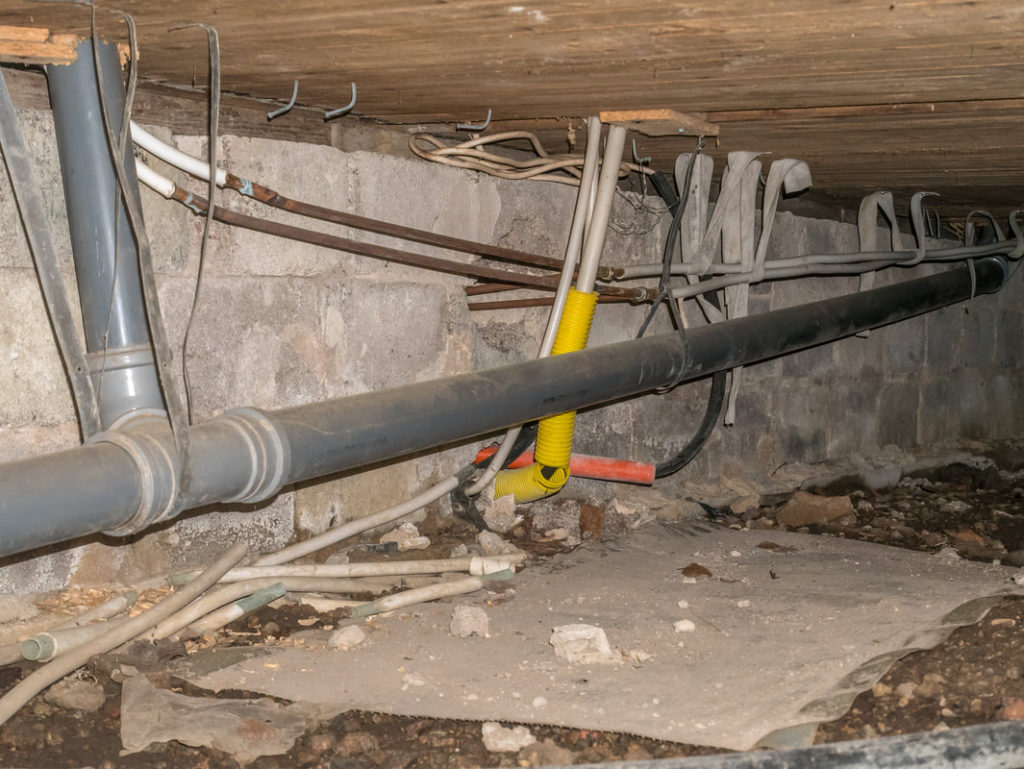 This Is A Picture Of A Crawl Space With Plumbing Pipes After Some Were Replaced By Homeowner And The Erie Pa Plumbers Will Replace The Rest